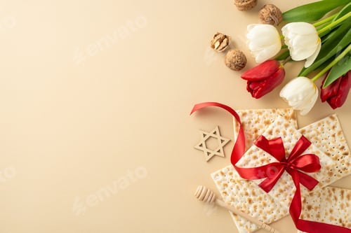 Preview: Chic Passover setup: overhead shot featuring ribbon-tied matzah, walnuts, honey spoon, star of David