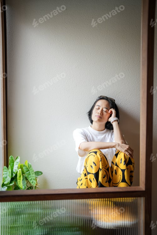 Preview: Thoughtful girl sitting on chair.