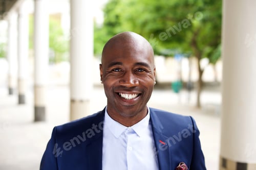 Preview: Smiling african businessman standing outdoors