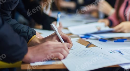 Preview: a man signs a document when registering for a conference