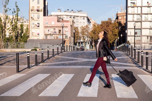 Preview: happy woman with suitcase crossing the street