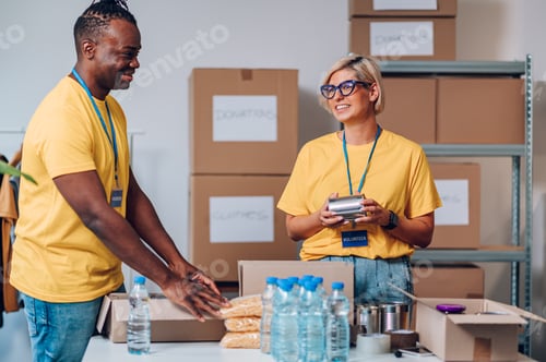 Preview: Group of multiracial volunteers working in community charity donation center
