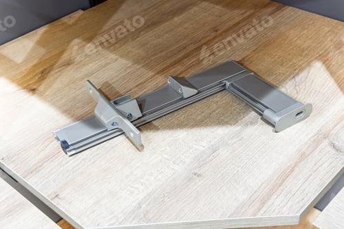Preview: Assembled metal furniture connecting hardware on wooden panel surface