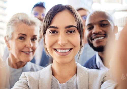 Preview: Portrait of a group of businesspeople taking selfies together in an office