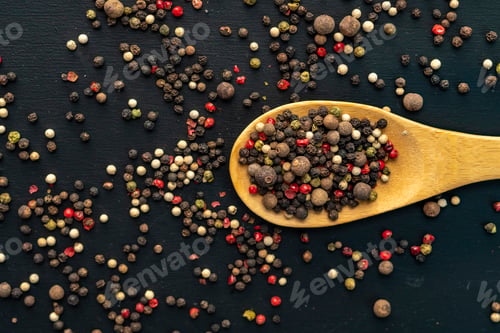 Preview: mix of black hot pepper, wooden bowl or spoon, black table or surfaces