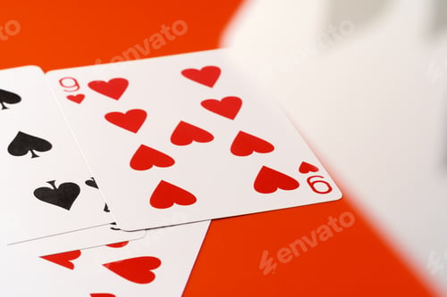 Preview: Playing cards on paper background close up