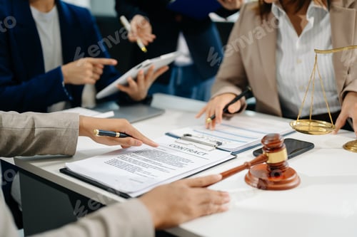 Preview: business people and lawyers discussing contract papers sitting at the table. Concepts of law,