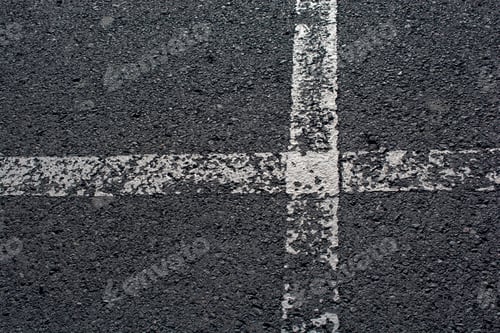 Preview: Top view shot of white shabby road lines on the asphalt
