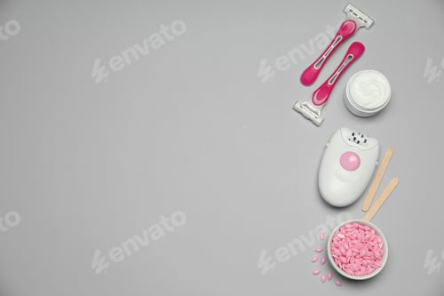 Preview: Modern epilator and other hair removal products on light grey background. Space for text