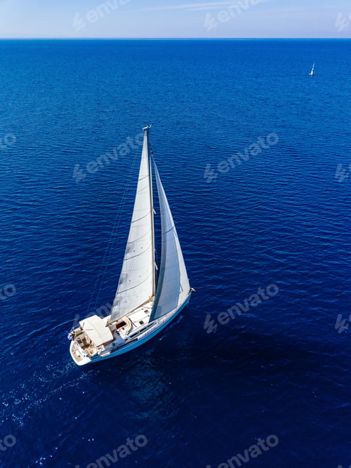 Preview: Aerial view from drone of white yacht in deep blue sea