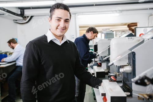 Preview: Man posing with his team in a workshop