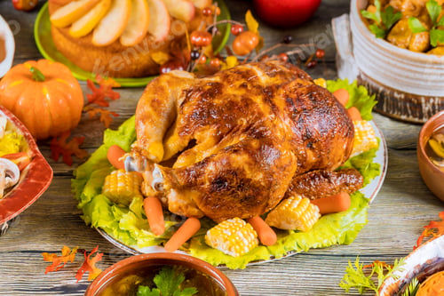 Preview: Thanksgiving dinner table with turkey, apple pie, pumpkin.