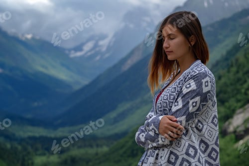 Preview: Stylish female hipster walking on top of mountains.