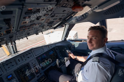 Preview: Smiling pilot posing for photo in cockpit
