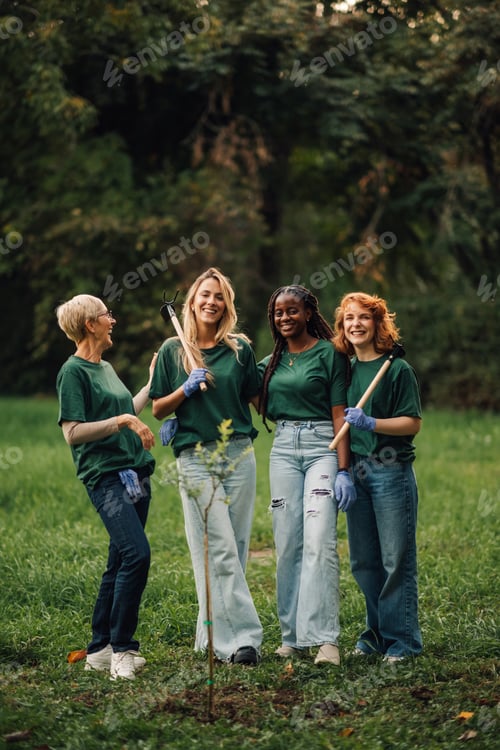 Preview: Four volunteers posing together after planting a tree