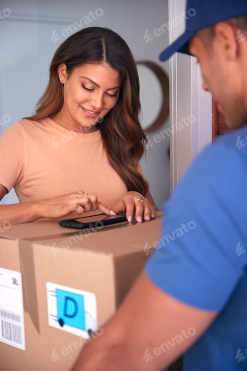 Preview: Woman Signing For Package Delivered By Courier On Mobile Phone