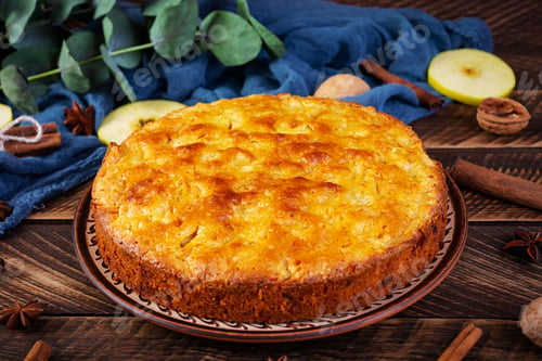 Preview: Delicious homemade apple pie on wooden background. Apple pie with ingredients, apples and cinnamon