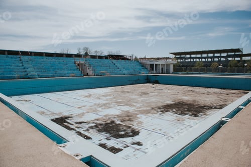 Preview: Old empty dry outdoor swimming pool in a dry park