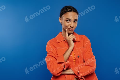 Preview: Vibrant woman in orange: a captivating pose