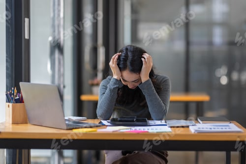 Preview: Portrait of tired young business Asian woman work with documents tax laptop computer in office. Sad,