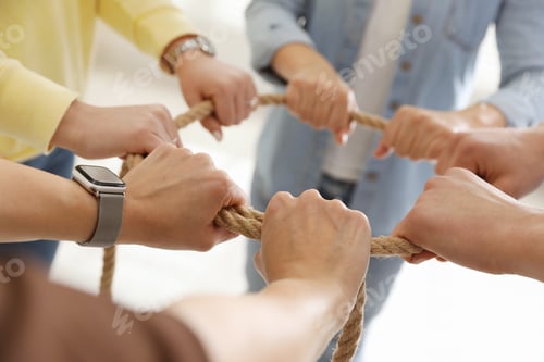 Preview: Unity concept. People holding rope together indoors, closeup