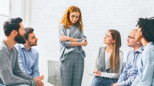 Preview: Addicted woman talking talking during rehab group meeting