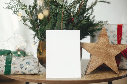 Preview: Christmas card mock up. Empty greeting card, stylish wrapped christmas gift, rustic star