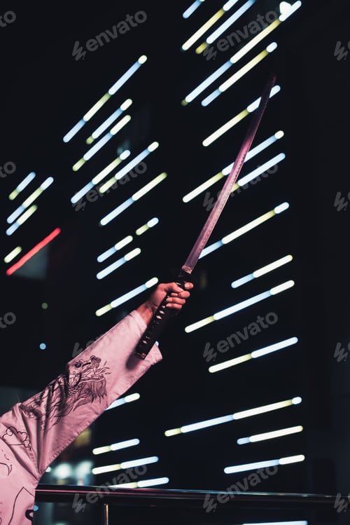 Preview: cropped image of girl in white kimono holding katana on street with neon light in evening, city of
