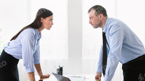 Preview: Businessman And Businesswoman Having Conflict At Work Standing In Office