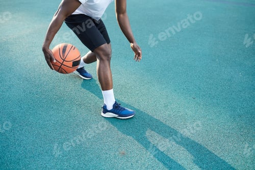 Preview: Unrecognizable African Man Dribbling Ball