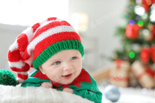Preview: Cute baby in Christmas costume at home