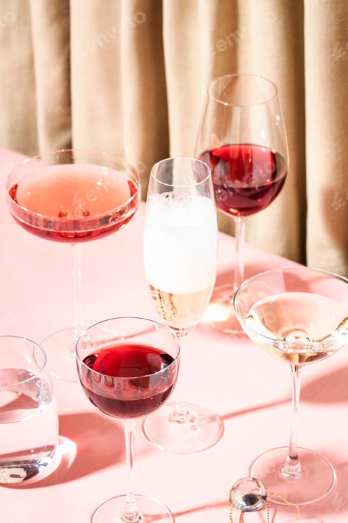 Preview: Many Glasses of Wine and Champagne on the Table.