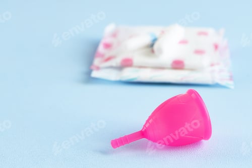 Preview: Menstrual cup and hygienic pad on table close up