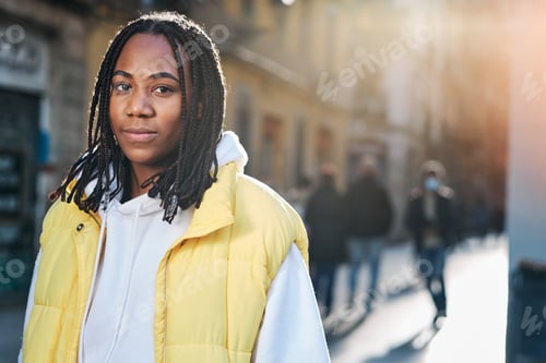 Preview: Woman looking to the camera outdoors on the street.