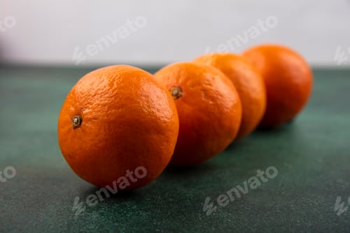 Preview: side view tangerines on a green background