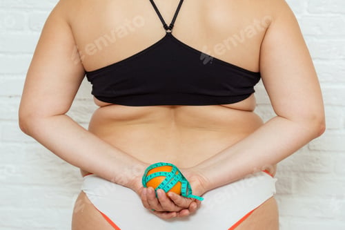 Preview: Beauty, shape, healthy and health care female concept. Overweight girl with measuring tape