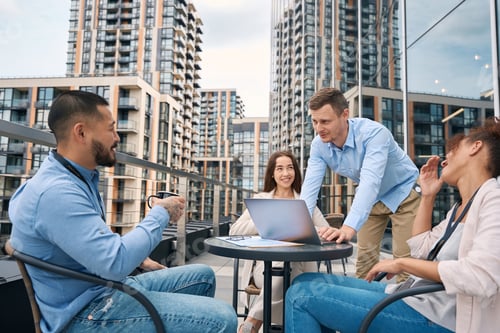Preview: Group of company employees holding meeting on office balcony