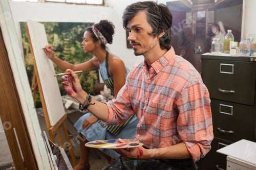 Preview: Man and woman painting on canvas
