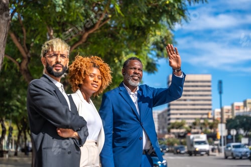 Preview: Multi-ethnic business people waiting for a taxi