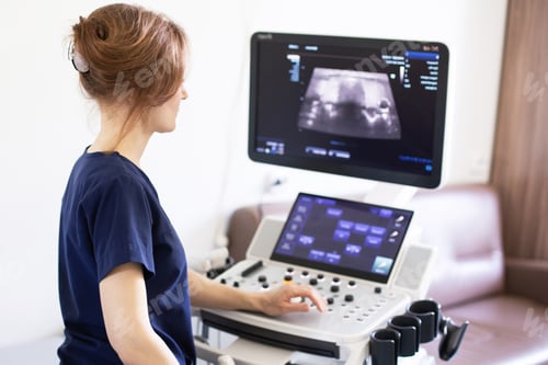 Preview: Doctor doing ultrasound scanning diagnostic of thyroid gland in clinic.
