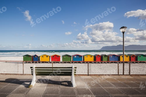 Preview: Bench overlooking colorful beach cabins in Kalk Bay, South Africa