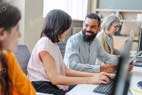 Preview: Diverse team of programmers working on computers in modern office