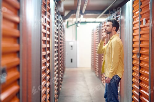 Preview: Thinking man in front of container in basement