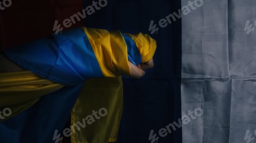 Preview: Russian flag and Ukraine flag in hands showing symbol of struggle war