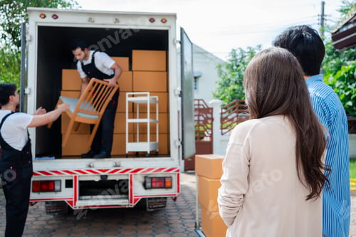 Preview: Asian Couple check while unloading boxes and furniture from a pickup truck