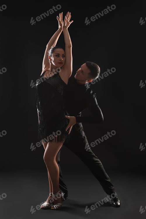 Preview: Couple of professional dancers on dark background