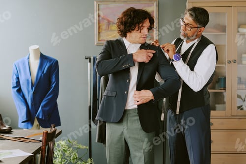Preview: Man Being Fitted For Suit By Tailor