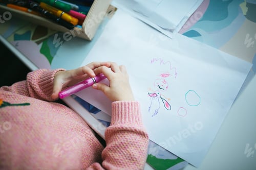 Preview: Child drawing happy fairy on paper. Top View