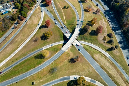 Preview: American freeway intersection with fast driving cars and trucks.