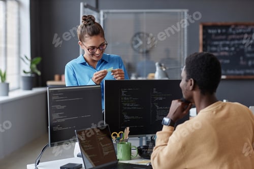 Preview: Colleagues working over computer codes